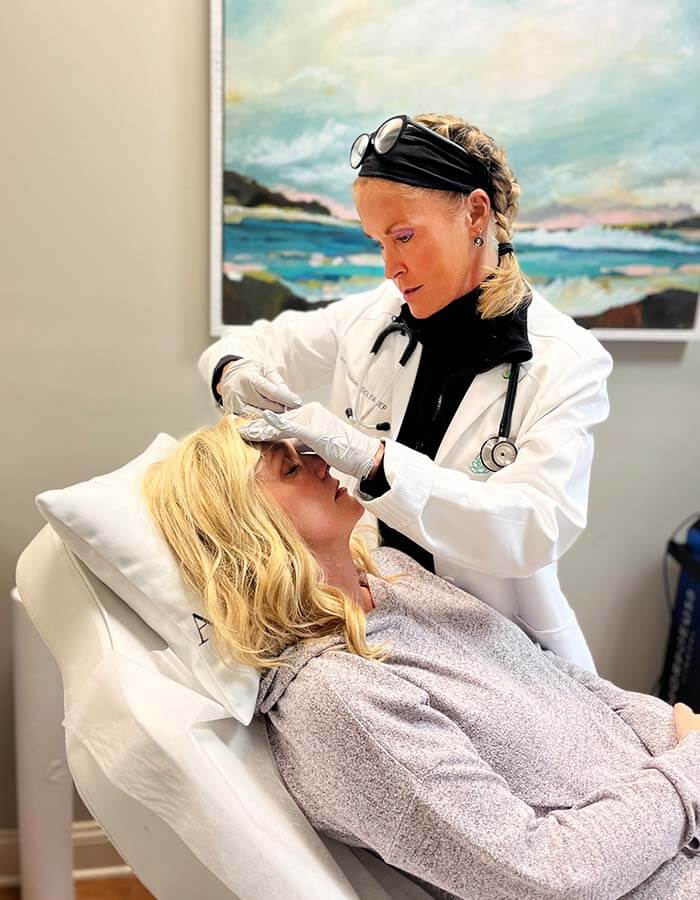 Avita Gallery - Dr. Amy treating a women in clinic